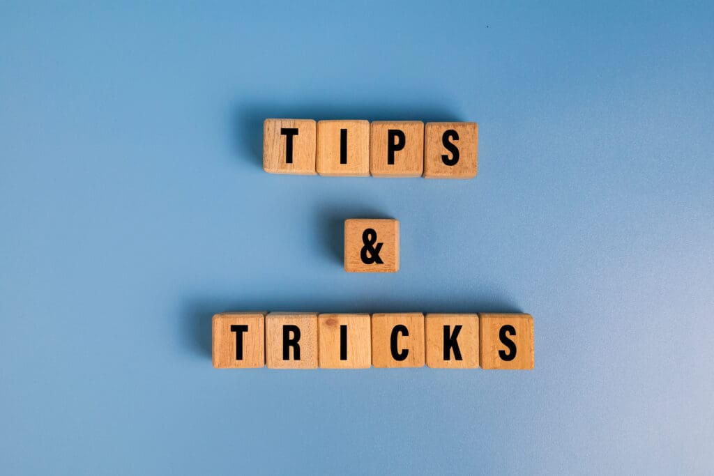 tips and tricks words on wooden blocks isolated on blue background tips and tricks words on wooden blocks isolated on blue background